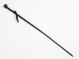 a close up of a black walking stick on a white surface