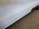 a close up of the front bumper of a white car