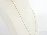 a close up of a necklace on a mannequin with a white background