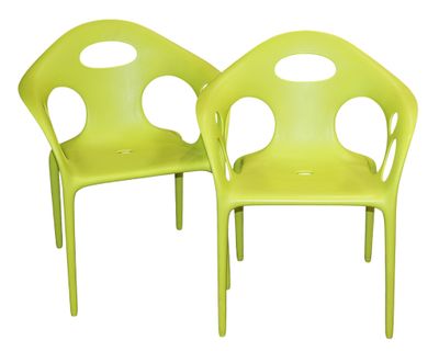 pair of lime green plastic chairs with holes on the back
