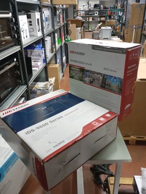 many boxes of electronics sitting on a table in a room