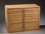 a close up of a wooden cabinet with many drawers