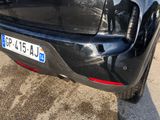 the rear end of a black car with a number plate on it