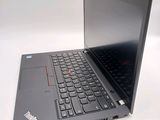 a laptop computer sitting on a table with a keyboard