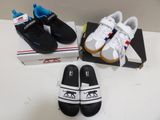 two pairs of black and white shoes are on a white table