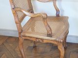 a wooden chair that is sitting on a parquet floor