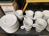 a lot of cups and saucers on a table