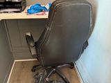a desk with a chair and a bag on the floor
