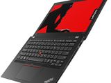 a laptop with a red screen and black keyboard on a white surface