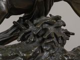 a bronze statue of a man on a horse on a rock