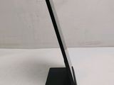 a tablet that is sitting on a stand on a table