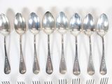six spoons and six forks arranged in a row