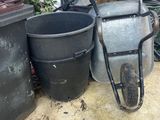 a pile of garbage sitting on the ground next to a fence