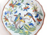 two plates with birds on them on a white surface