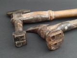 two old hammers that are laying on a table