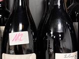several bottles of wine are lined up on a shelf in a store