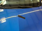 a close up of a blue car with a sticker on it