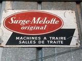 a sign that says surge melotte original on the side of a building
