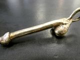 a metal object on a black surface with a silver object
