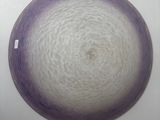a purple and white plate sitting on a white table