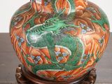 a lamp that has a dragon on it on a table