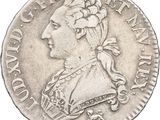 gros plan d'une pièce de monnaie sur laquelle figure une tête de femme