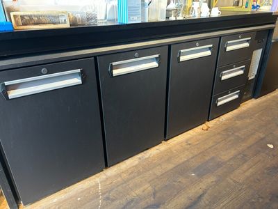 an image of a kitchen with black cabinets and a counter top