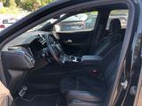 the interior of a car with the door open and the driver ' s seat down