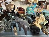 a lot of statues and figurines on display in a store