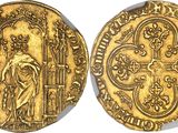a gold coin with an image of a man holding a cross