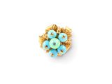 a close up of a blue flower broochle on a white surface