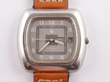 a close up of a watch with a brown leather strap