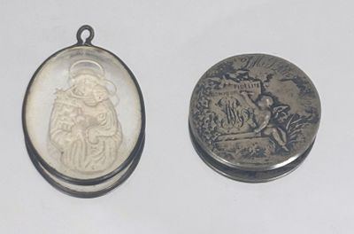 a silver coin and a silver coin with a picture of santa on it