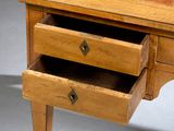 a small wooden desk with two drawers on it