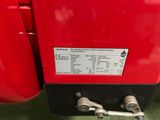 a close up of a red fire extinguisor on display