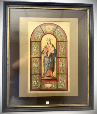 a framed picture of a woman holding a child in a stained glass window
