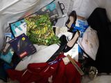 a suitcase filled with clothes and other items on a bed