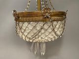 a gold and white chandelier hanging from a ceiling