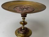 a gold plate with a flower design on it
