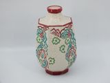 an image of a ceramic vase with a red lid