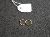 a close up of two rings on a black surface with a price tag