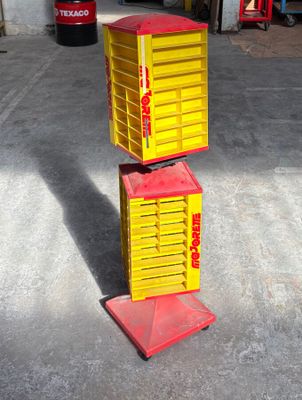 yellow and red boxes stacked on top of each other in a garage