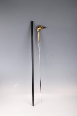 pair of black and gold canes on a white background