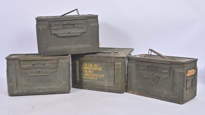 three military boxes are stacked on top of each other on a white surface