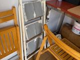 two folding chairs and a table in a room