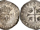 a silver coin with a crown on top of it