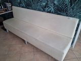a white couch that is sitting on a tiled floor