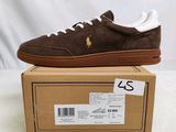 the brown sued sneaker is on top of a cardboard box