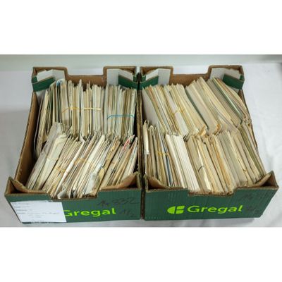 two boxes filled with a lot of papers sitting on top of a table