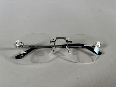 pair of glasses on a table with a white background